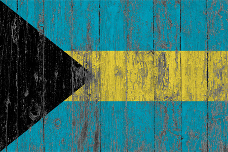Flag of Bahamas painted on worn out wooden texture background.の写真素材