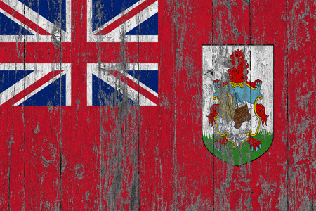 Flag of Bermuda painted on worn out wooden texture background.の写真素材