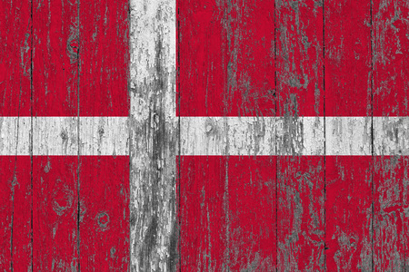 Flag of Denmark painted on worn out wooden texture background.の写真素材