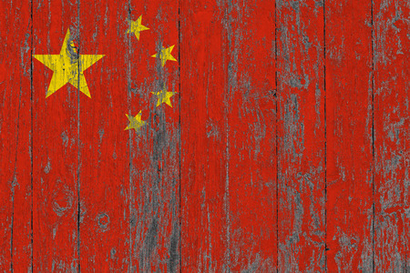 Flag of China painted on worn out wooden texture background.の写真素材
