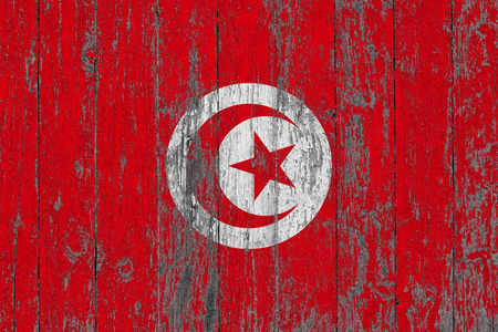 Flag of Tunisia painted on worn out wooden texture background.の写真素材