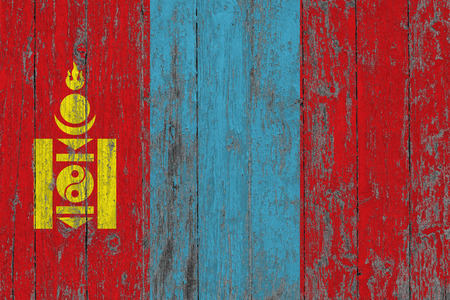 Flag of Mongolia painted on worn out wooden texture background.の写真素材