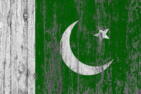 Flag of Pakistan painted on worn out wooden texture background.の写真素材