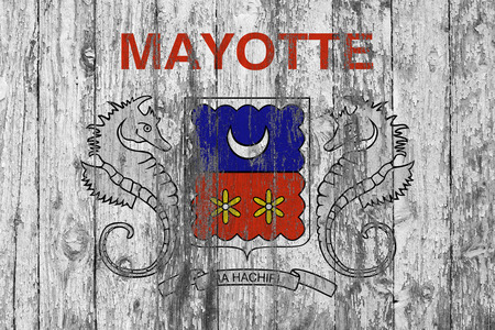 Flag of Mayotte painted on worn out wooden texture background.の写真素材