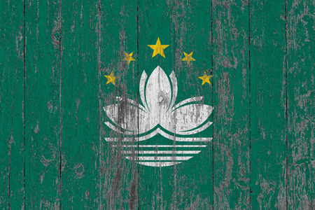 Flag of Macao painted on worn out wooden texture background.の写真素材