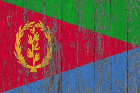 Flag of Eritrea painted on worn out wooden texture background.の写真素材
