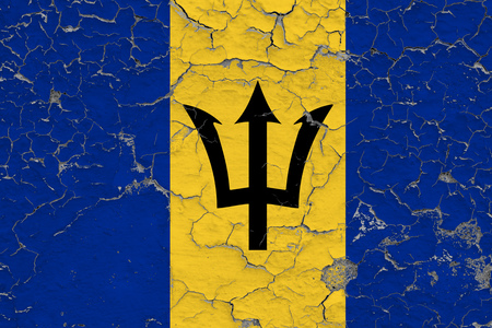 Flag of Barbados painted on cracked dirty wall. National pattern on vintage style surface.の写真素材