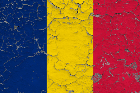 Flag of Chad painted on cracked dirty wall. National pattern on vintage style surface.の写真素材