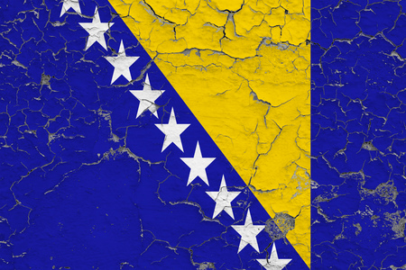 Flag of Bosnia Herzegovina painted on cracked dirty wall. National pattern on vintage style surface.の写真素材