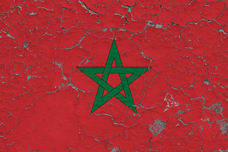 Flag of Morocco painted on cracked dirty wall. National pattern on vintage style surface.の写真素材
