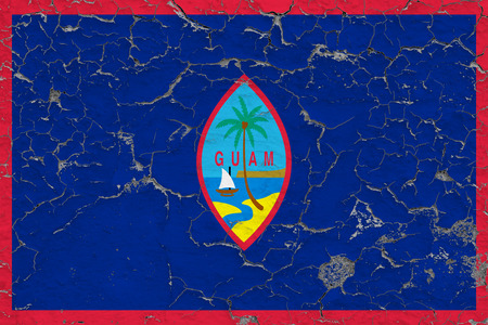 Flag of Guam painted on cracked dirty wall. National pattern on vintage style surface.の写真素材