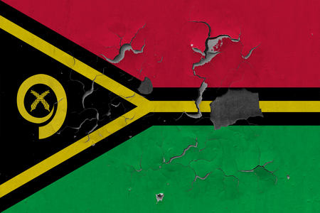 Close up grungy, damaged and weathered Vanuatu flag on wall peeling off paint to see inside surface.の写真素材