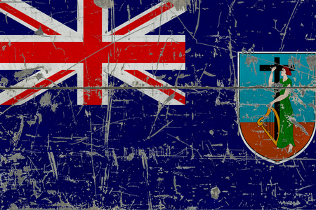 Grunge Montserrat flag on old scratched wooden surface. National vintage background.の写真素材