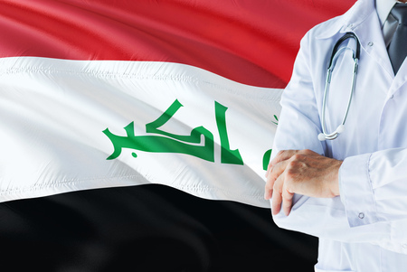Iraqi Doctor standing with stethoscope on Iraq flag background. National healthcare system concept, medical theme.の写真素材