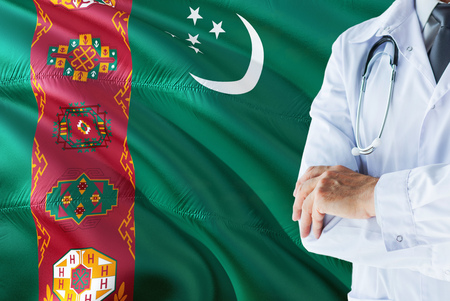 Turkmen Doctor standing with stethoscope on Turkmenistan flag background. National healthcare system concept, medical theme.の写真素材