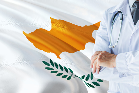 Cypriot Doctor standing with stethoscope on Cyprus flag background. National healthcare system concept, medical theme.の写真素材