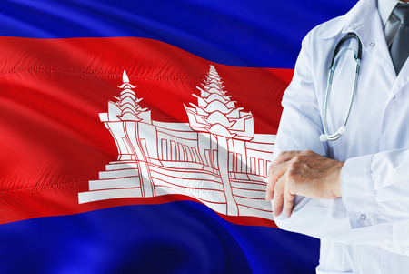 Cambodian Doctor standing with stethoscope on Cambodia flag background. National healthcare system concept, medical theme.の写真素材