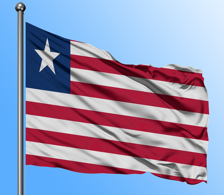 Liberia flag waving in the deep blue sky background. Isolated national flag. Macro view shot.の写真素材