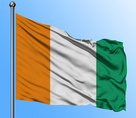 Cote D'Ivoire flag waving in the deep blue sky background. Isolated national flag. Macro view shot.の写真素材
