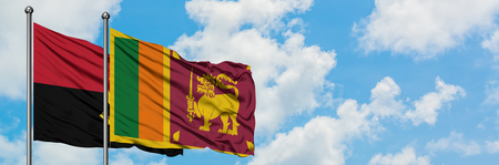 Angola and Sri Lanka flag waving in the wind against white cloudy blue sky together. Diplomacy concept, international relations.の写真素材