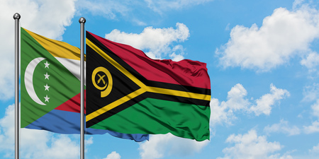 Comoros and Vanuatu flag waving in the wind against white cloudy blue sky together. Diplomacy concept, international relations.の写真素材