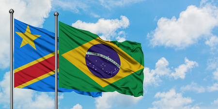 Congo and Brazil flag waving in the wind against white cloudy blue sky together. Diplomacy concept, international relations.の写真素材