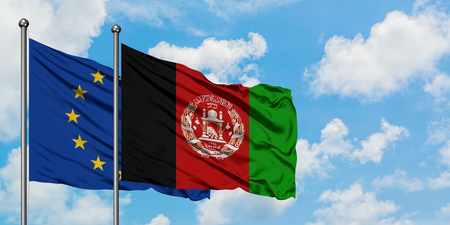 European Union and Afghanistan flag waving in the wind against white cloudy blue sky together. Diplomacy concept, international relations.