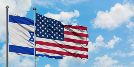 Israel and United States flag waving in the wind against white cloudy blue sky together. Diplomacy concept, international relations.の写真素材