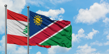 Lebanon and Namibia flag waving in the wind against white cloudy blue sky together. Diplomacy concept, international relations.の写真素材