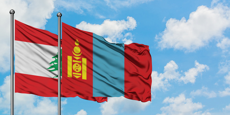 Lebanon and Mongolia flag waving in the wind against white cloudy blue sky together. Diplomacy concept, international relations.の写真素材