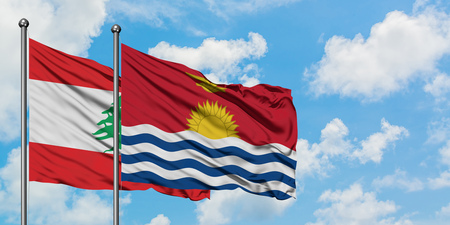 Lebanon and Kiribati flag waving in the wind against white cloudy blue sky together. Diplomacy concept, international relations.の写真素材