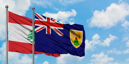 Lebanon and Turks And Caicos Islands flag waving in the wind against white cloudy blue sky together. Diplomacy concept, international relations.の写真素材