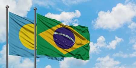 Palau and Brazil flag waving in the wind against white cloudy blue sky together. Diplomacy concept, international relations.の写真素材