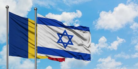 Romania and Israel flag waving in the wind against white cloudy blue sky together. Diplomacy concept, international relations.の写真素材