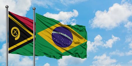 Vanuatu and Brazil flag waving in the wind against white cloudy blue sky together. Diplomacy concept, international relations.の写真素材