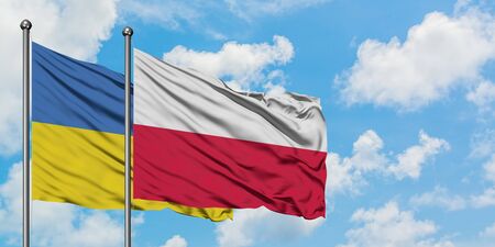 Ukraine and Poland flag waving in the wind against white cloudy blue sky together. Diplomacy concept, international relations.