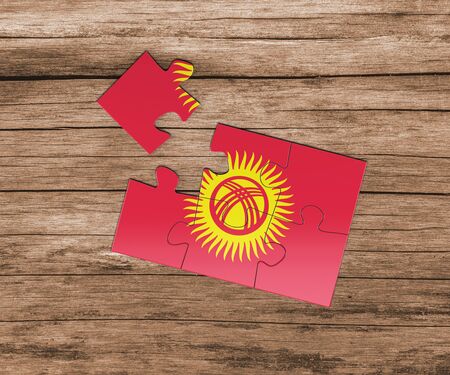 Kyrgyzstan national flag on jigsaw puzzle. One piece is missing. Danger concept.の写真素材