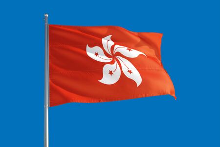 Hong Kong national flag waving in the wind on a deep blue sky. High quality fabric. International relations concept.の写真素材
