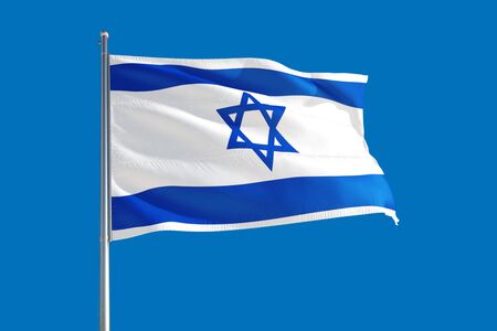 Israel national flag waving in the wind on a deep blue sky. High quality fabric. International...