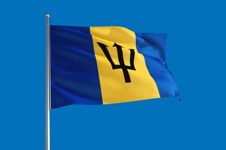 Barbados national flag waving in the wind on a deep blue sky. High quality fabric. International relations concept.の写真素材