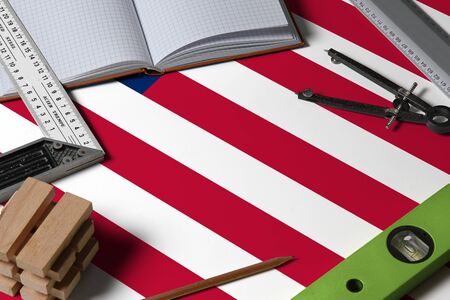 United States national flag on profession concept with architect desk and tools background. Top view mock-up.の写真素材