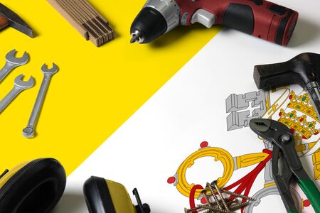 Vatican City flag on repair tool concept wooden table background. Mechanical service theme with...