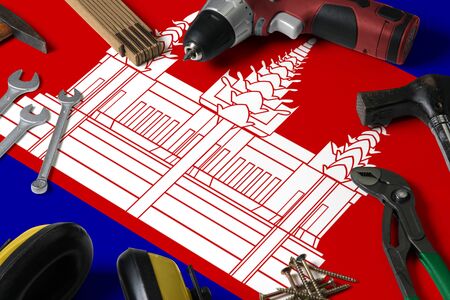 Cambodia flag on repair tool concept wooden table background. Mechanical service theme with national...