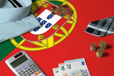 Portugal flag on minimal money concept table. Coins and financial objects on flag surface. National economy theme.の写真素材