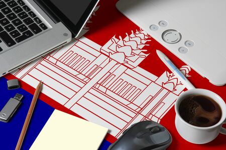 Cambodia national flag on top view work space of creative designer with laptop, computer keyboard,...