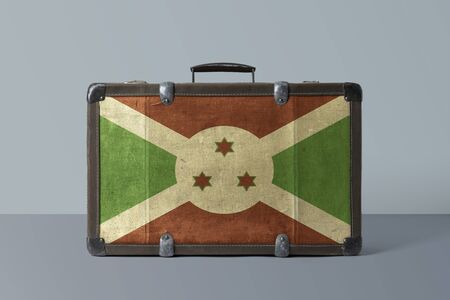 Burundi flag on old vintage leather suitcase with national concept. Retro brown luggage with copy space text.の写真素材