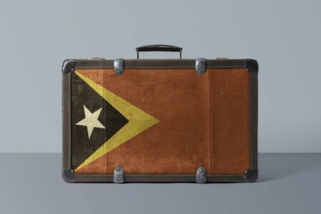 East Timor flag on old vintage leather suitcase with national concept. Retro brown luggage with copy space text.の写真素材