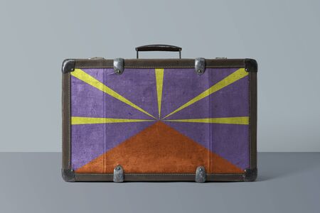 Reunion flag on old vintage leather suitcase with national concept. Retro brown luggage with copy...