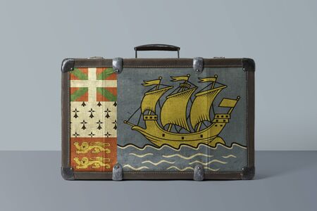 Saint Pierre And Miquelon flag on old vintage leather suitcase with national concept. Retro brown luggage with copy space text.の写真素材