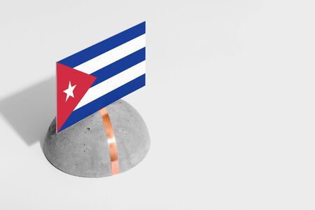 Cuba flag tagged on rounded stone. White isolated background. Side view minimal national concept.の写真素材
